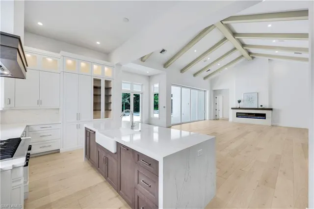 a large white kitchen with cabinets