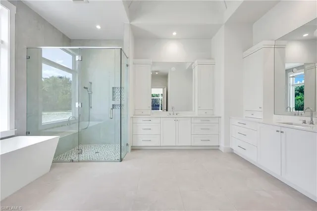 a spacious bathroom with a granite countertop sink a toilet and a mirror