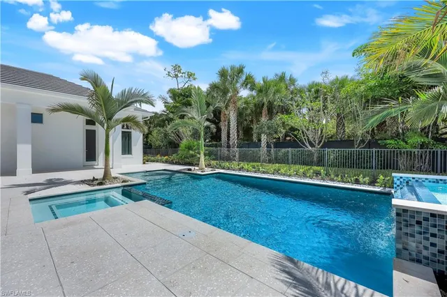 a view of a house with backyard porch and sitting area