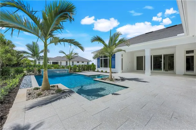 a view of a house with backyard and sitting area