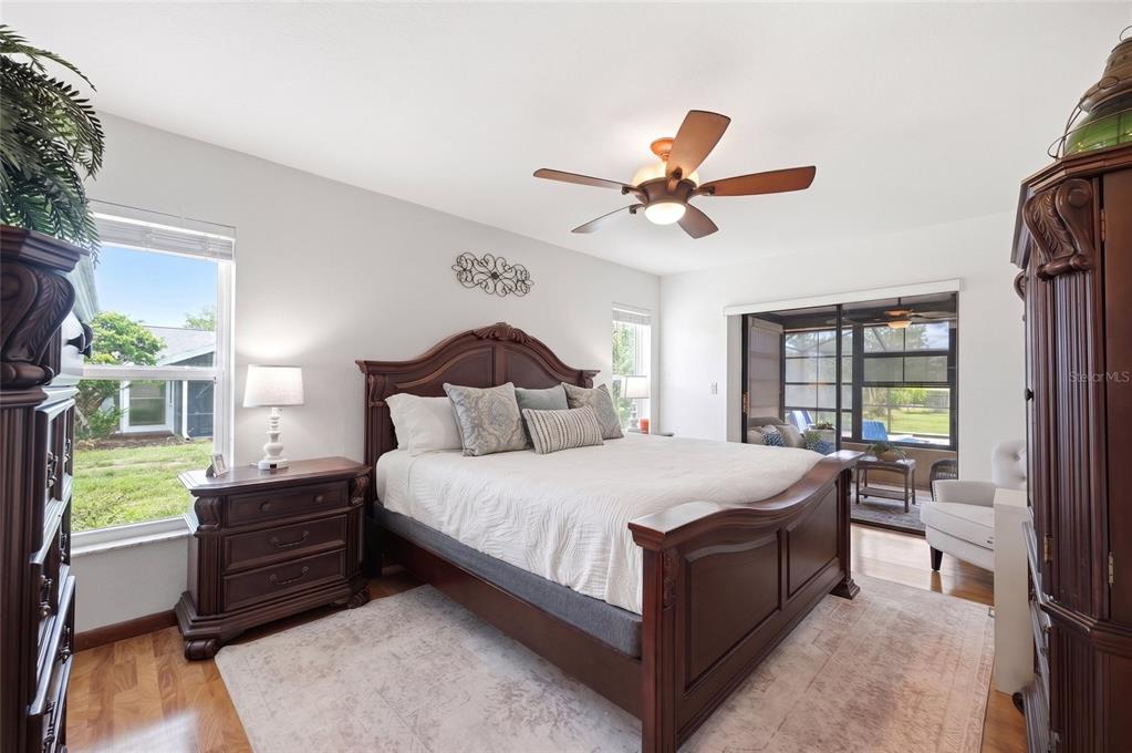 5227 Suwannee Road Weeki Wachee, FL 34607 - Photo 22 of 62 a bedroom with a bed and a chandelier