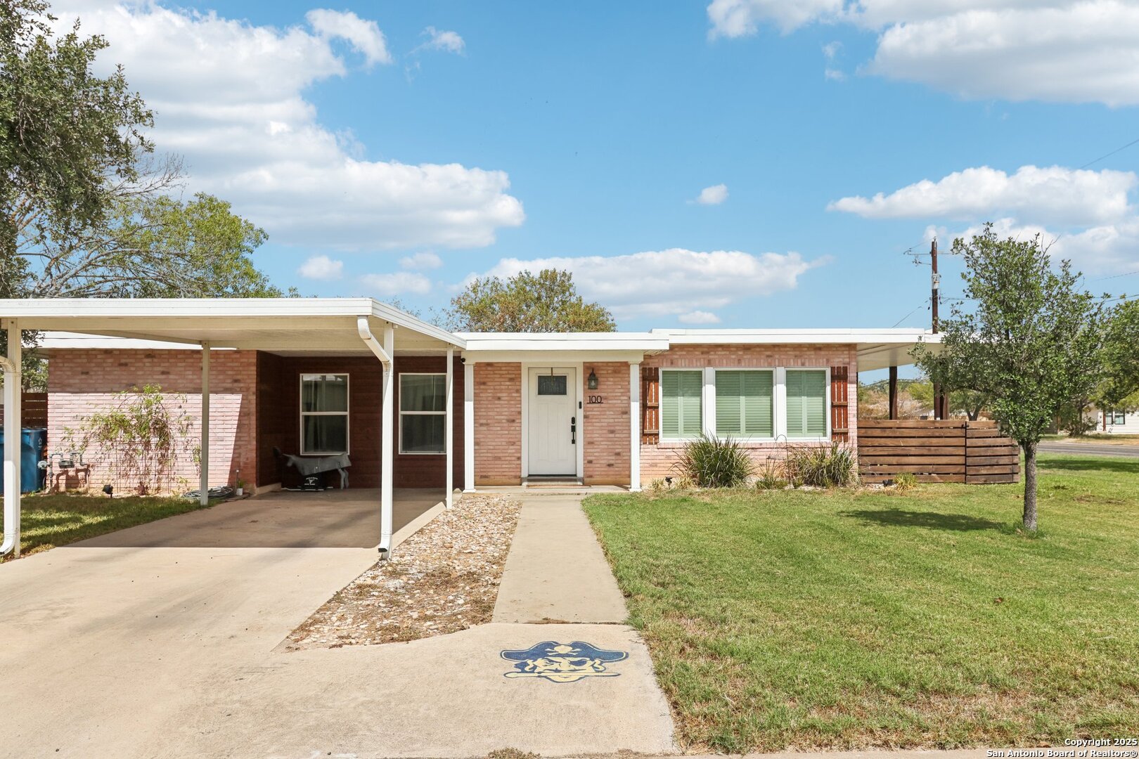 100 North Carroll Street Poth, TX 78147 - Photo 2 of 58 a view of a house with backyard and garden
