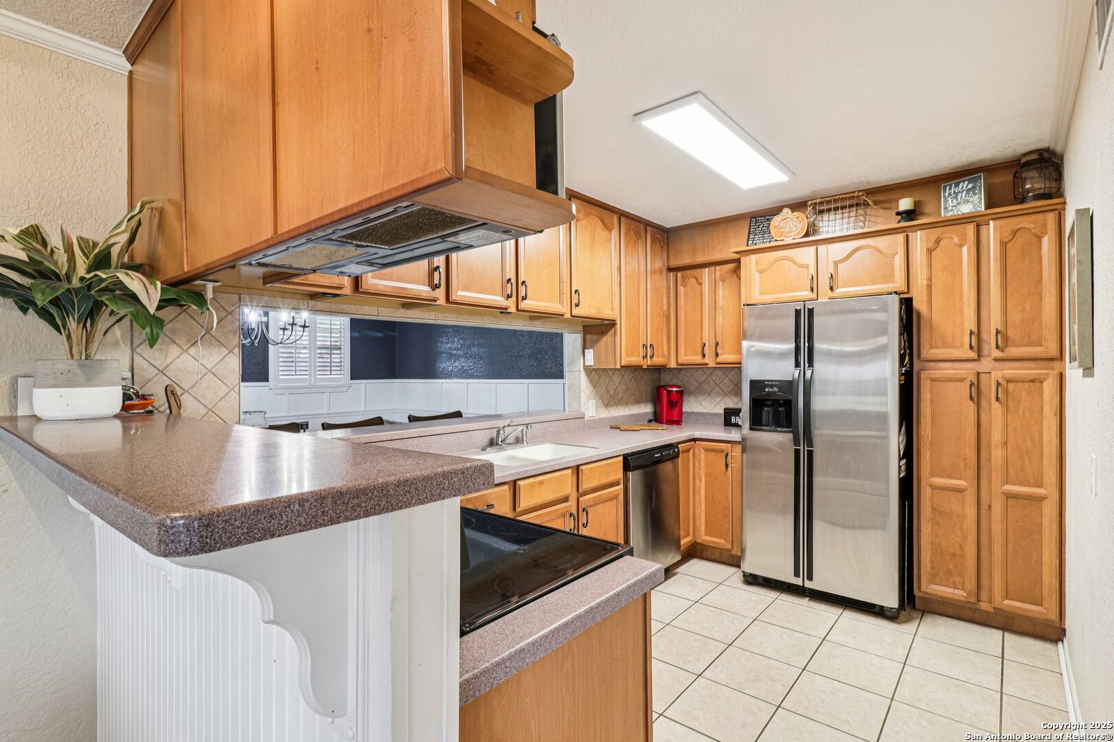 100 North Carroll Street Poth, TX 78147 - Photo 22 of 58 a kitchen with stainless steel appliances granite countertop a refrigerator a sink and a stove