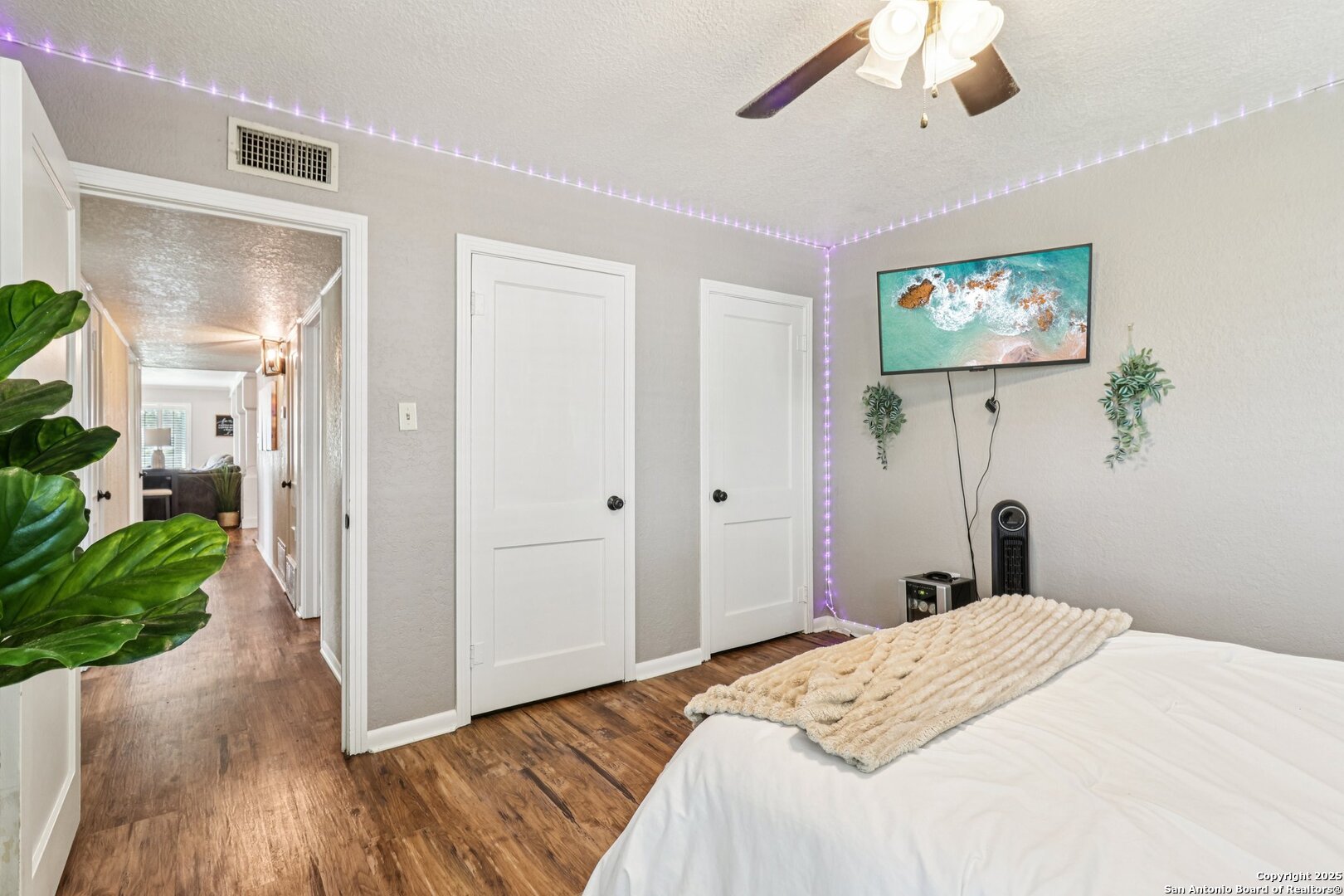 100 North Carroll Street Poth, TX 78147 - Photo 25 of 58 a bedroom with a bed and a wooden floor