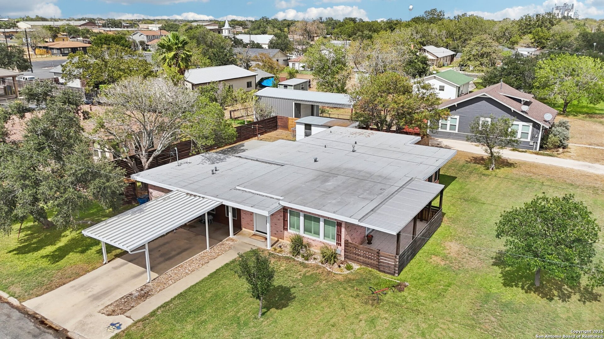 100 North Carroll Street Poth, TX 78147 - Photo 3 of 58 an aerial view of a house with a yard