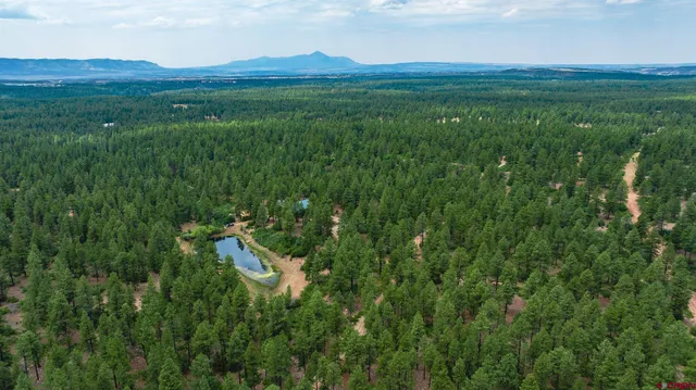 a view of a balcony with a yard
