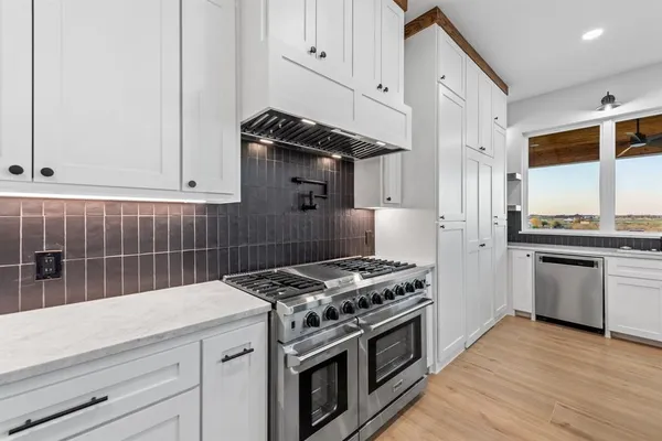 a kitchen with granite countertop a stove and a sink