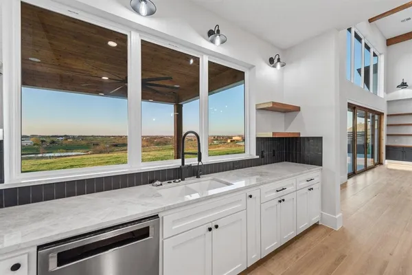 a kitchen with granite countertop a sink and a stove