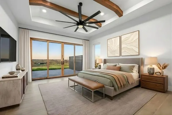 a spacious bedroom with a bed a couch and a ceiling fan