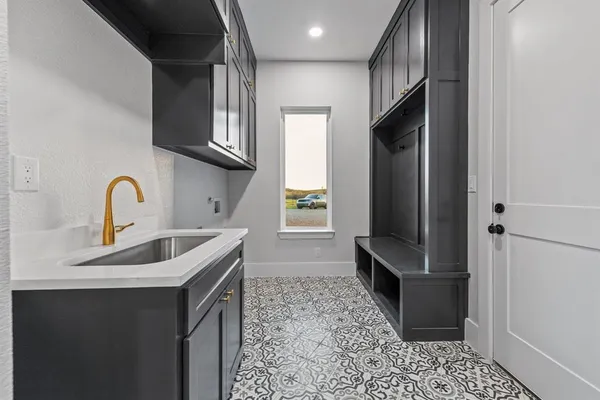 a kitchen with stainless steel appliances a sink stove and a refrigerator