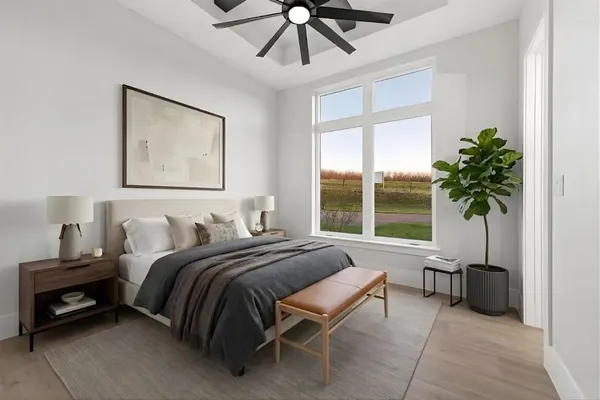 a bedroom with a bed and a large window