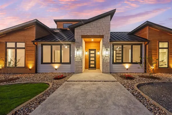 a front view of a house with a yard