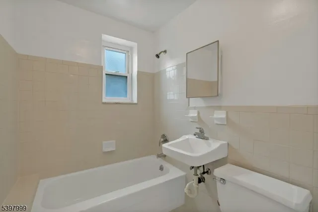 a bathroom with a sink a toilet and a bathtub