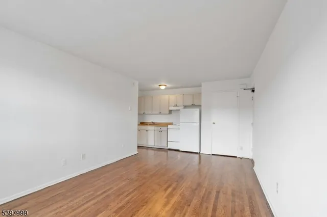 a view of a kitchen with wooden floor and a sink