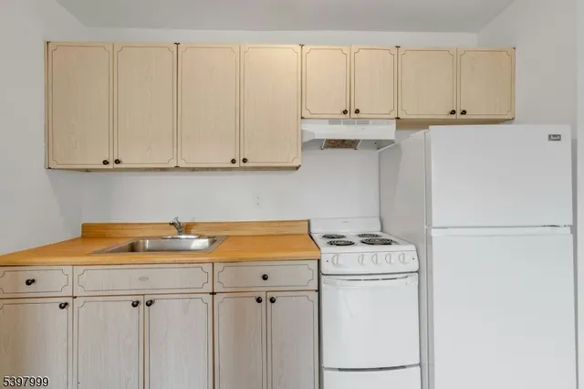 a kitchen with stainless steel appliances white cabinets and a sink