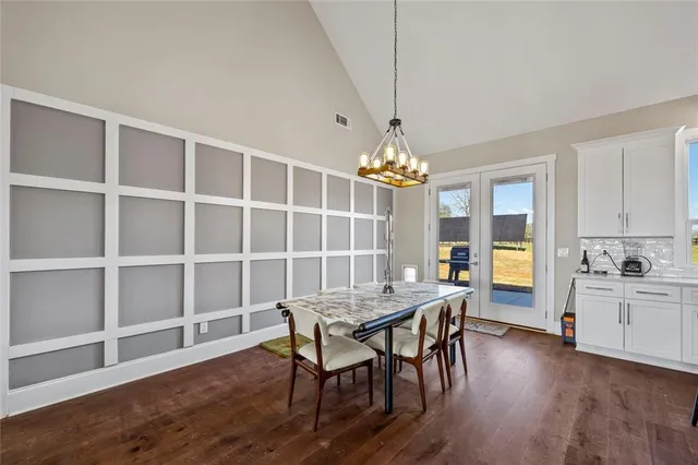 a kitchen with a sink cabinets and wooden floor