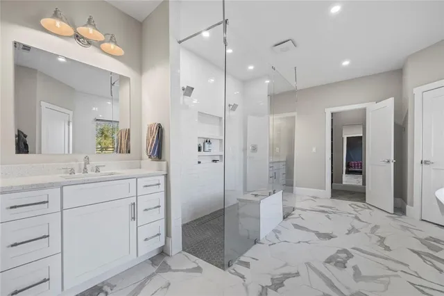 a bathroom with a double vanity sink mirror and shower