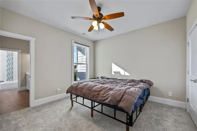 a bedroom with a bed and a ceiling fan