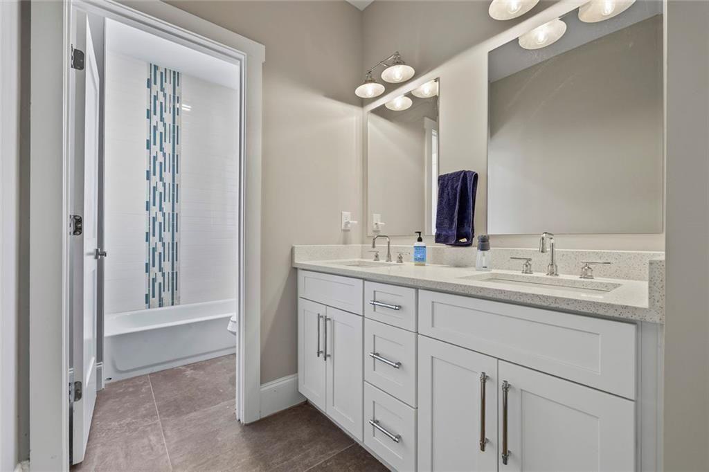 7588 Highway 98 Commerce, GA 30530 - Photo 27 of 50 a bathroom with a double vanity sink and a mirror