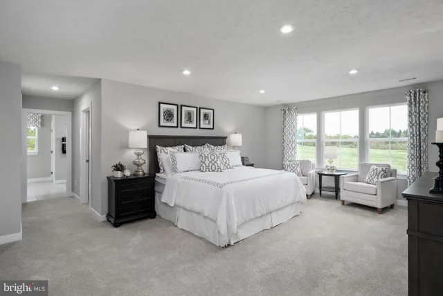 a spacious bedroom with a bed and glass wall