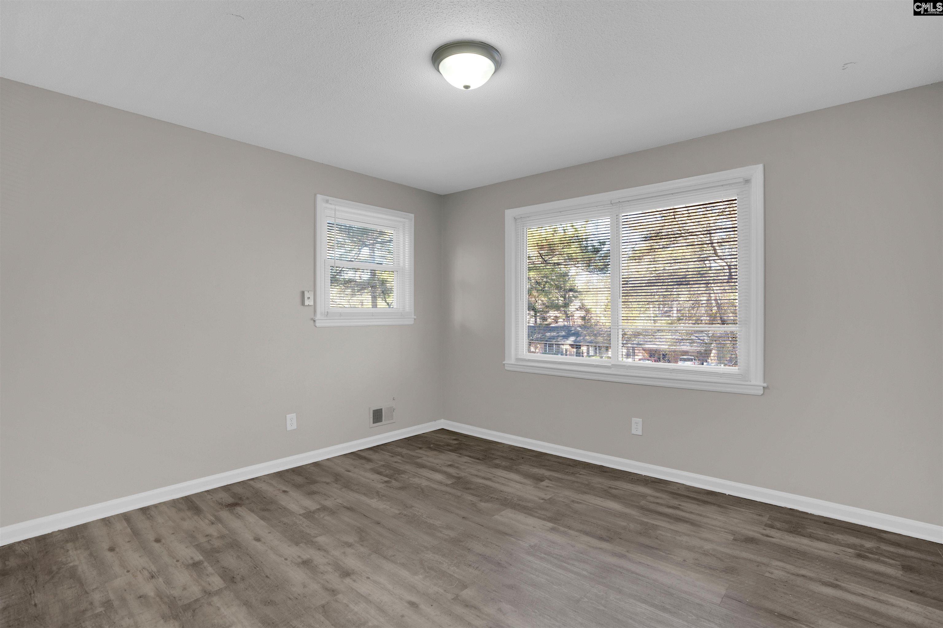 2620 Pleasant Ridge Drive Columbia, SC 29209 - Photo 28 of 37 an empty room with wooden floor and windows