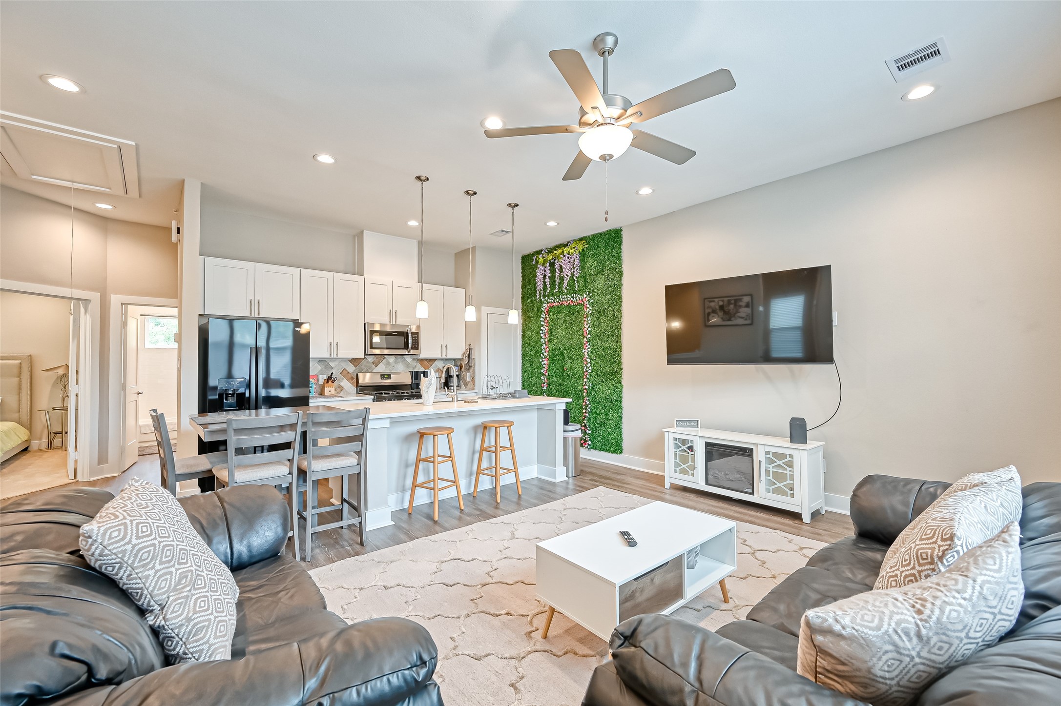 882 Fortune Street Houston, TX 77088 - Photo 11 of 18 a living room with furniture kitchen view and a flat screen tv