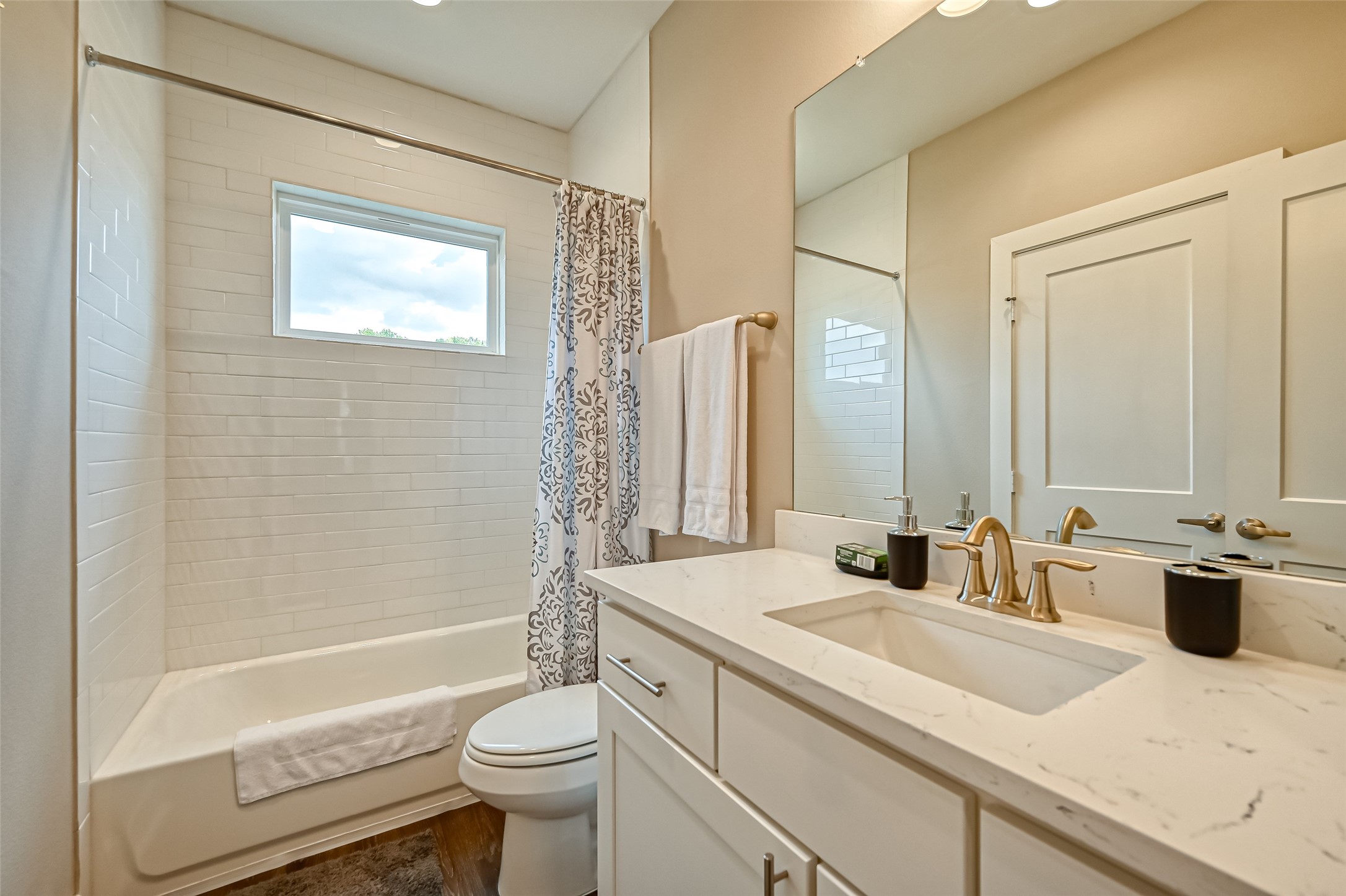 882 Fortune Street Houston, TX 77088 - Photo 14 of 18 a bathroom with a double vanity sink toilet and shower