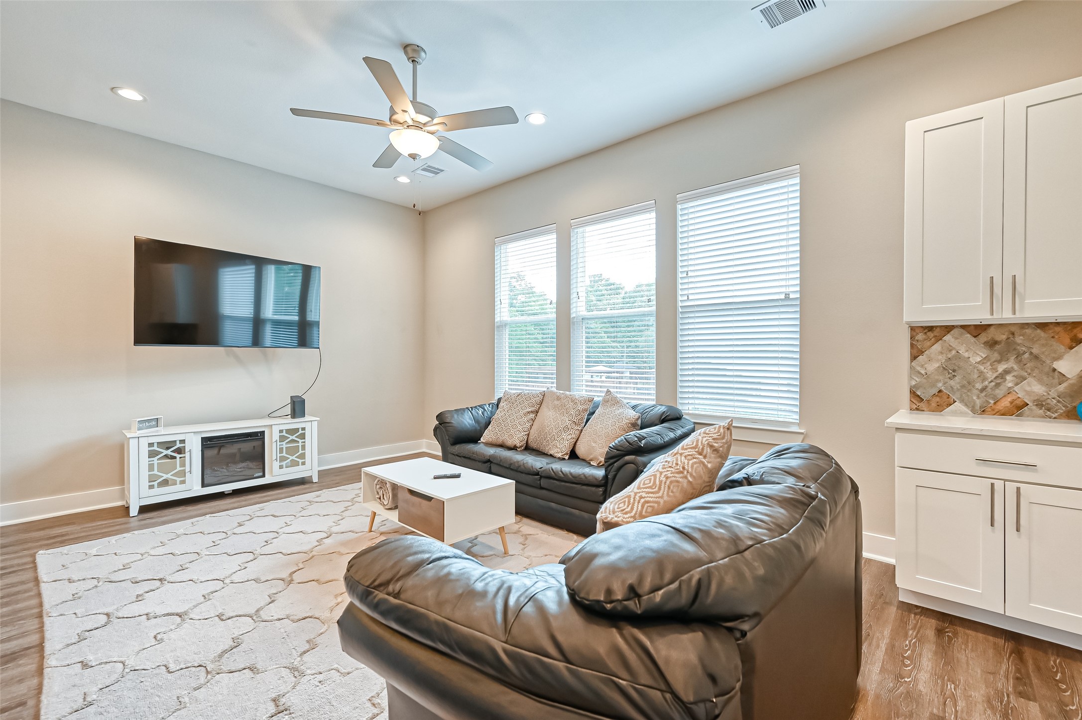882 Fortune Street Houston, TX 77088 - Photo 9 of 18 a living room with furniture a flat screen tv and a fireplace