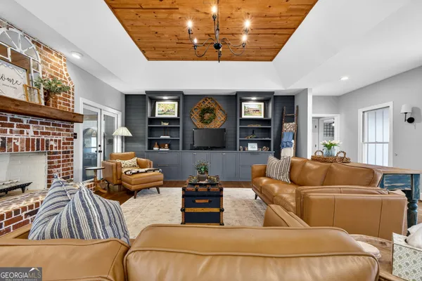 a kitchen with stainless steel appliances kitchen island granite countertop a table chairs and a refrigerator