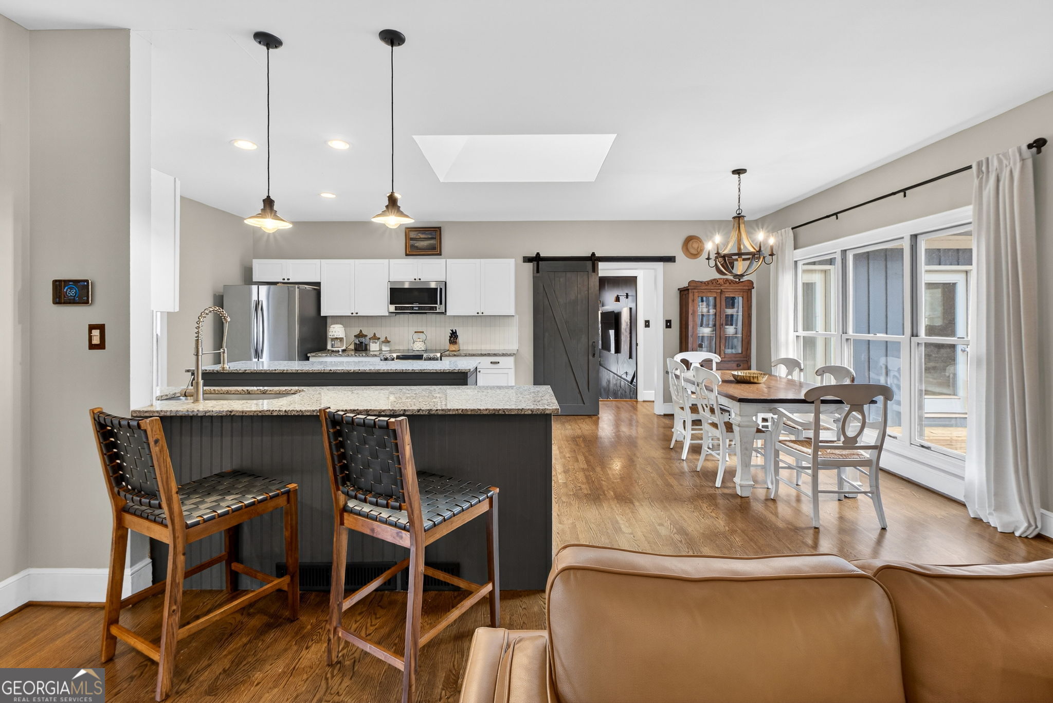 7581 Old Zebulon Road Molena, GA 30258 - Photo 16 of 79 a dining room with furniture a chandelier and wooden floor