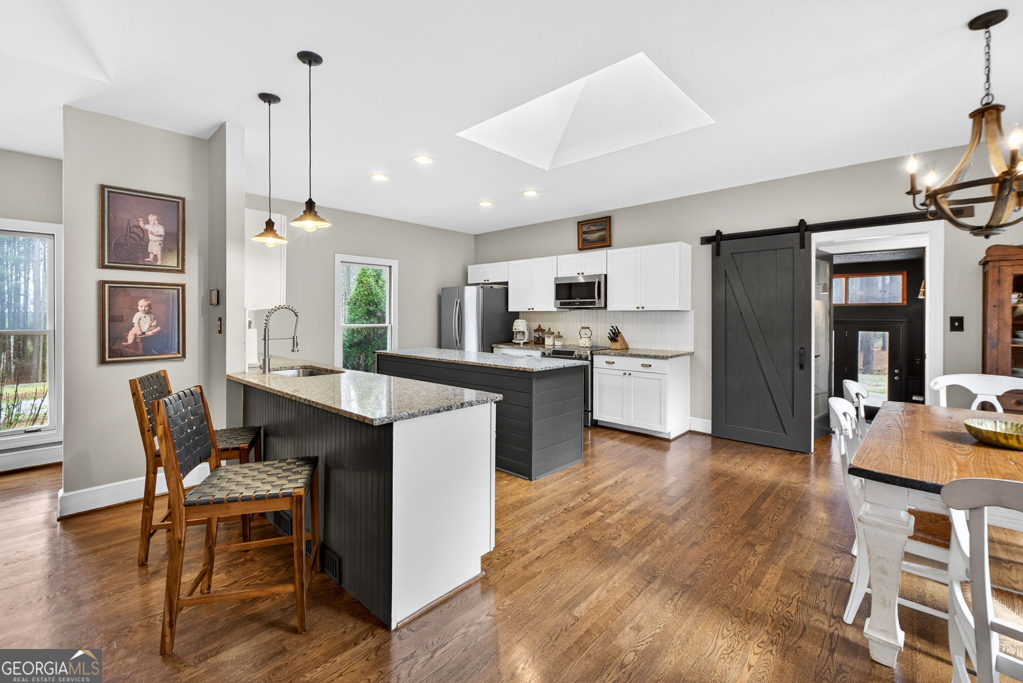 7581 Old Zebulon Road Molena, GA 30258 - Photo 17 of 79 a kitchen with stainless steel appliances kitchen island granite countertop a table chairs and a refrigerator