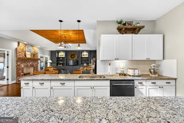 a view of a dining room with furniture wooden floor and chandelier