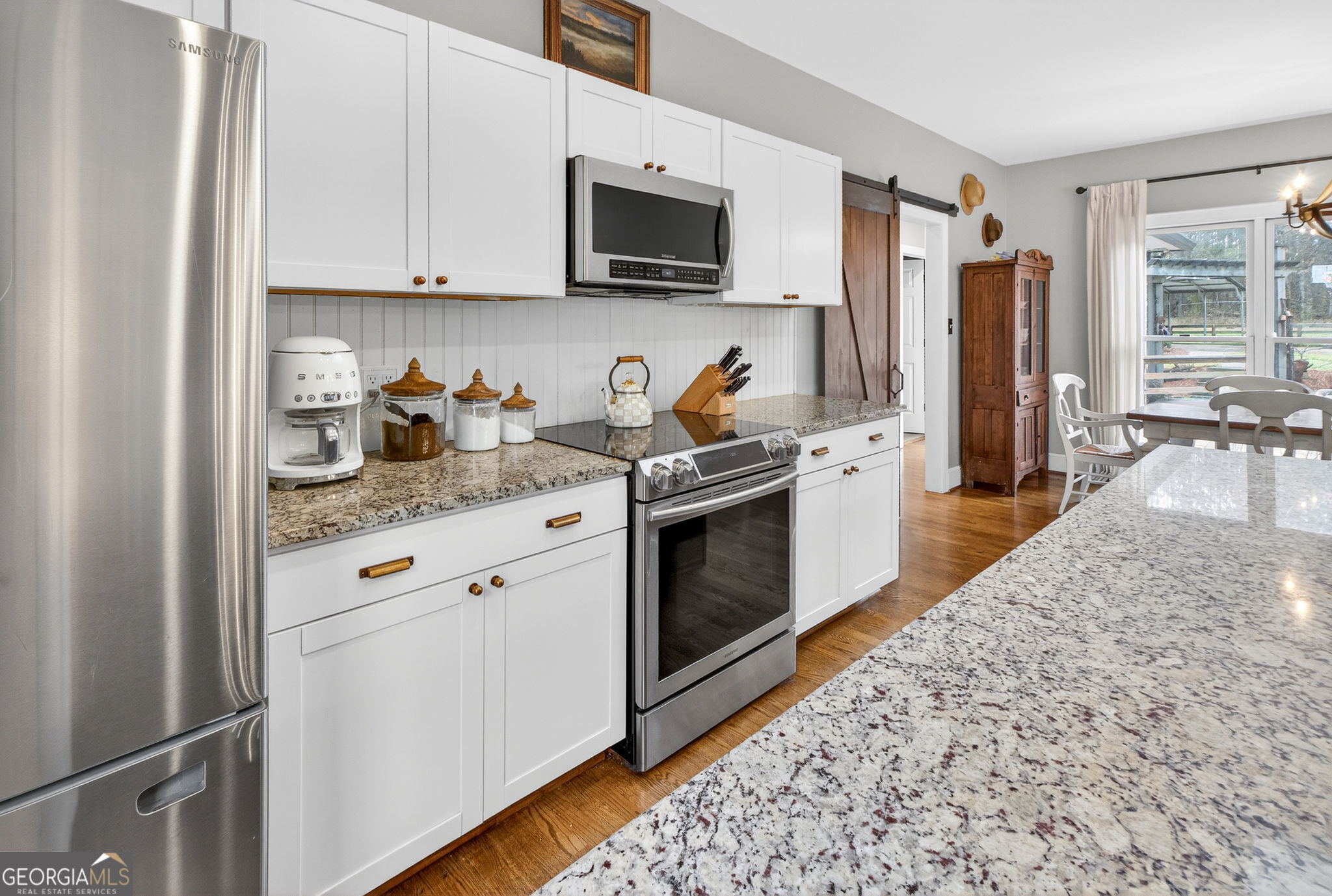7581 Old Zebulon Road Molena, GA 30258 - Photo 20 of 79 a kitchen with stainless steel appliances granite countertop a stove a sink and a microwave