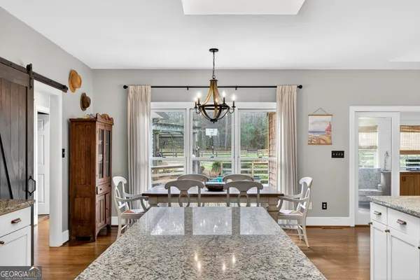 a view of a workspace with furniture and a kitchen