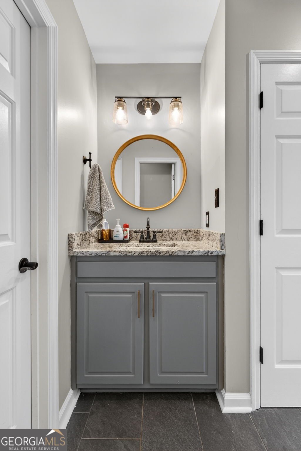 7581 Old Zebulon Road Molena, GA 30258 - Photo 37 of 79 a bathroom with a granite countertop sink and a mirror