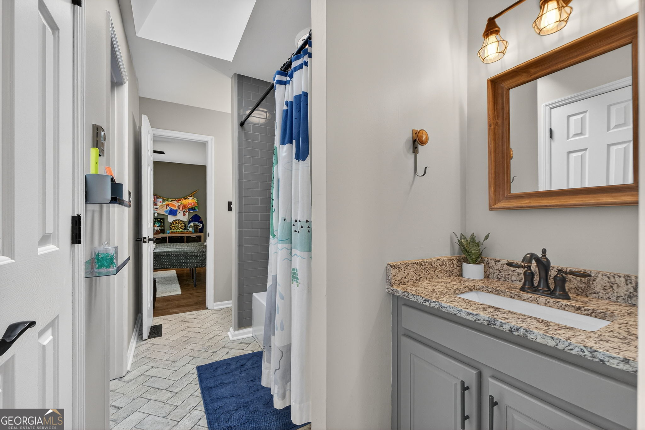 7581 Old Zebulon Road Molena, GA 30258 - Photo 42 of 79 a en suite bathroom with a granite countertop sink and a mirror