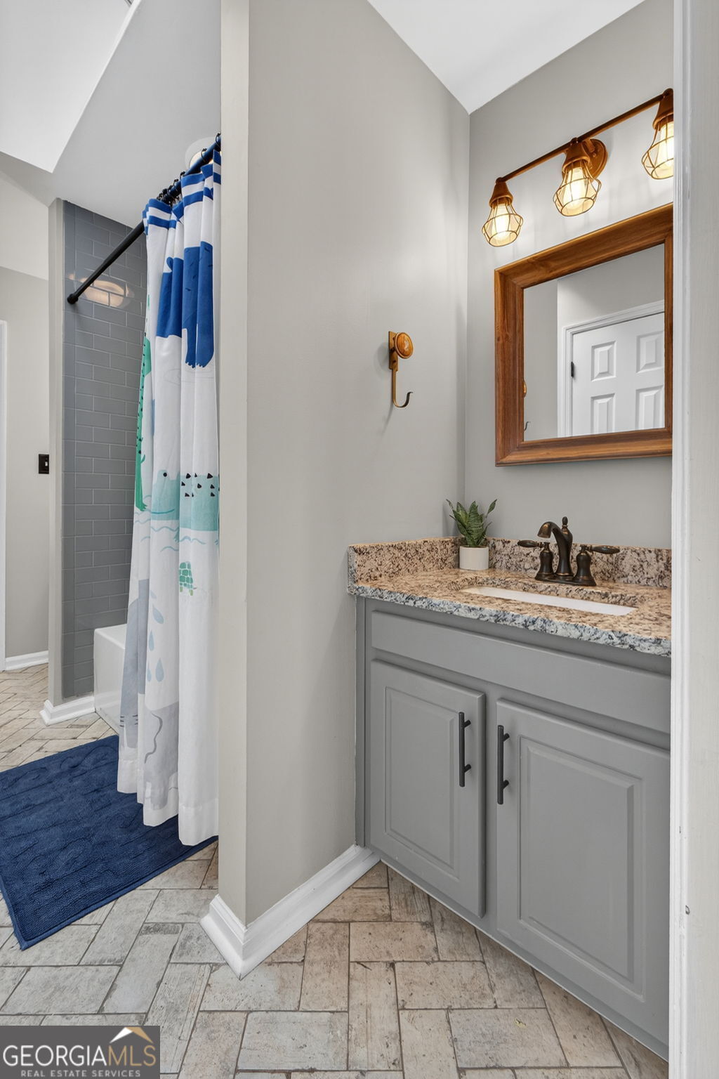 7581 Old Zebulon Road Molena, GA 30258 - Photo 43 of 79 a bathroom with a sink and a mirror