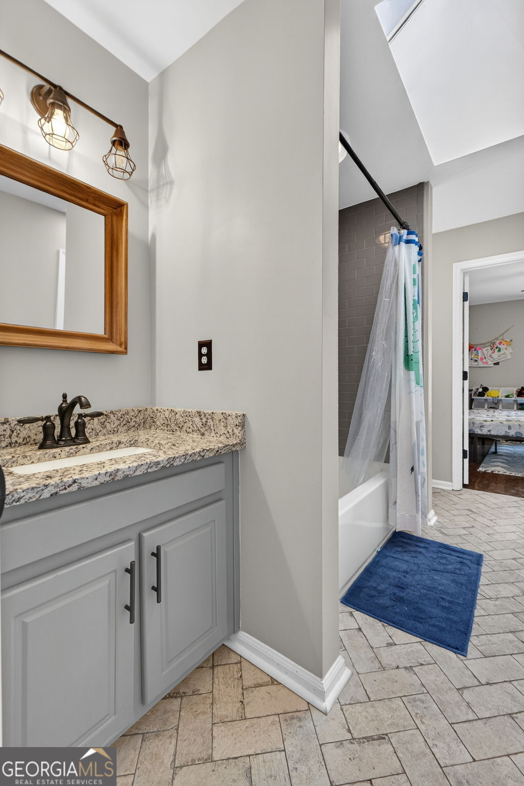 7581 Old Zebulon Road Molena, GA 30258 - Photo 44 of 79 a en suite bathroom with a granite countertop sink and a mirror