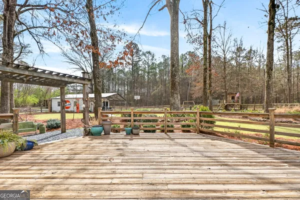 a view of a house with a lush green forest