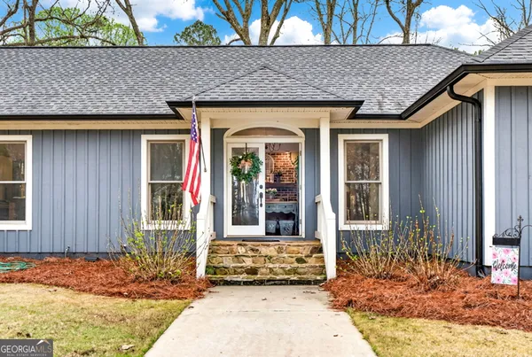 a living room with furniture a fireplace and a large window