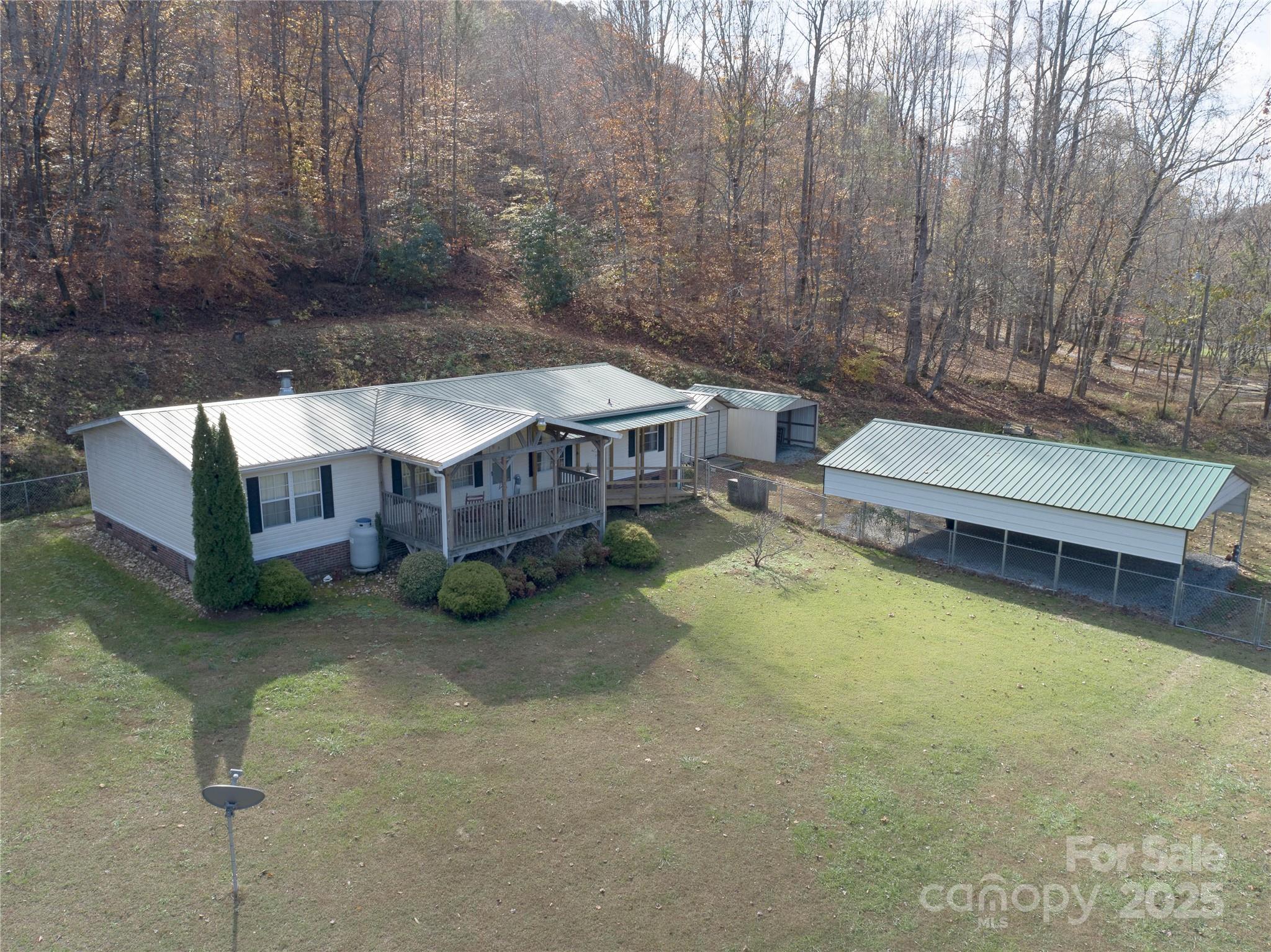1922 Zacks Fork Road Lenoir, NC 28645 - Photo 1 of 27 a view of a house with a yard patio and sitting area