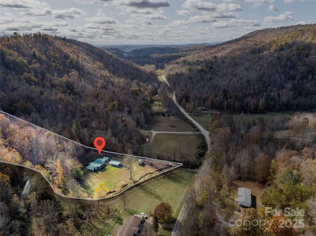 a view of a backyard with chairs and table