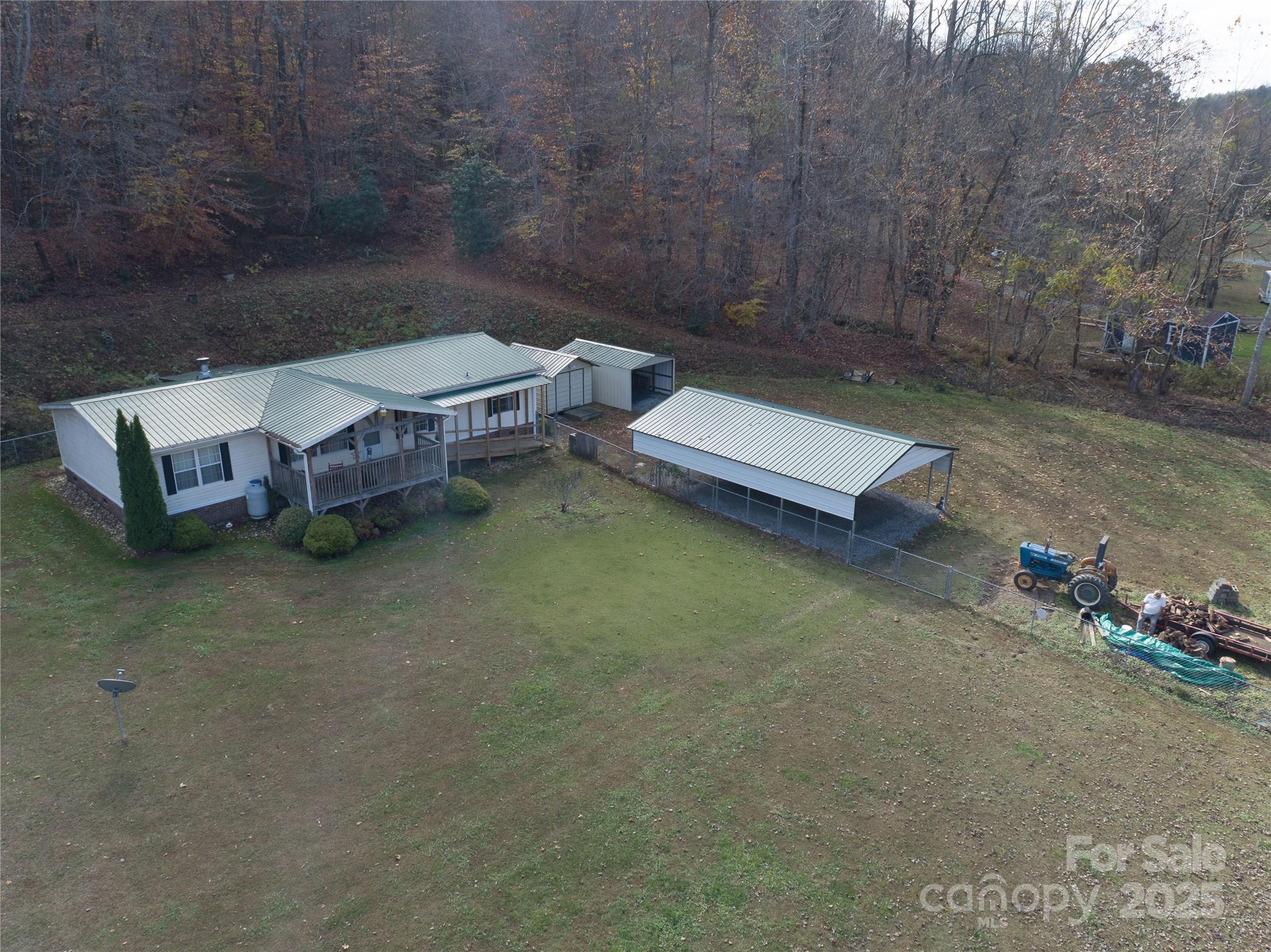 1922 Zacks Fork Road Lenoir, NC 28645 - Photo 26 of 27 a view of a backyard with chairs and table