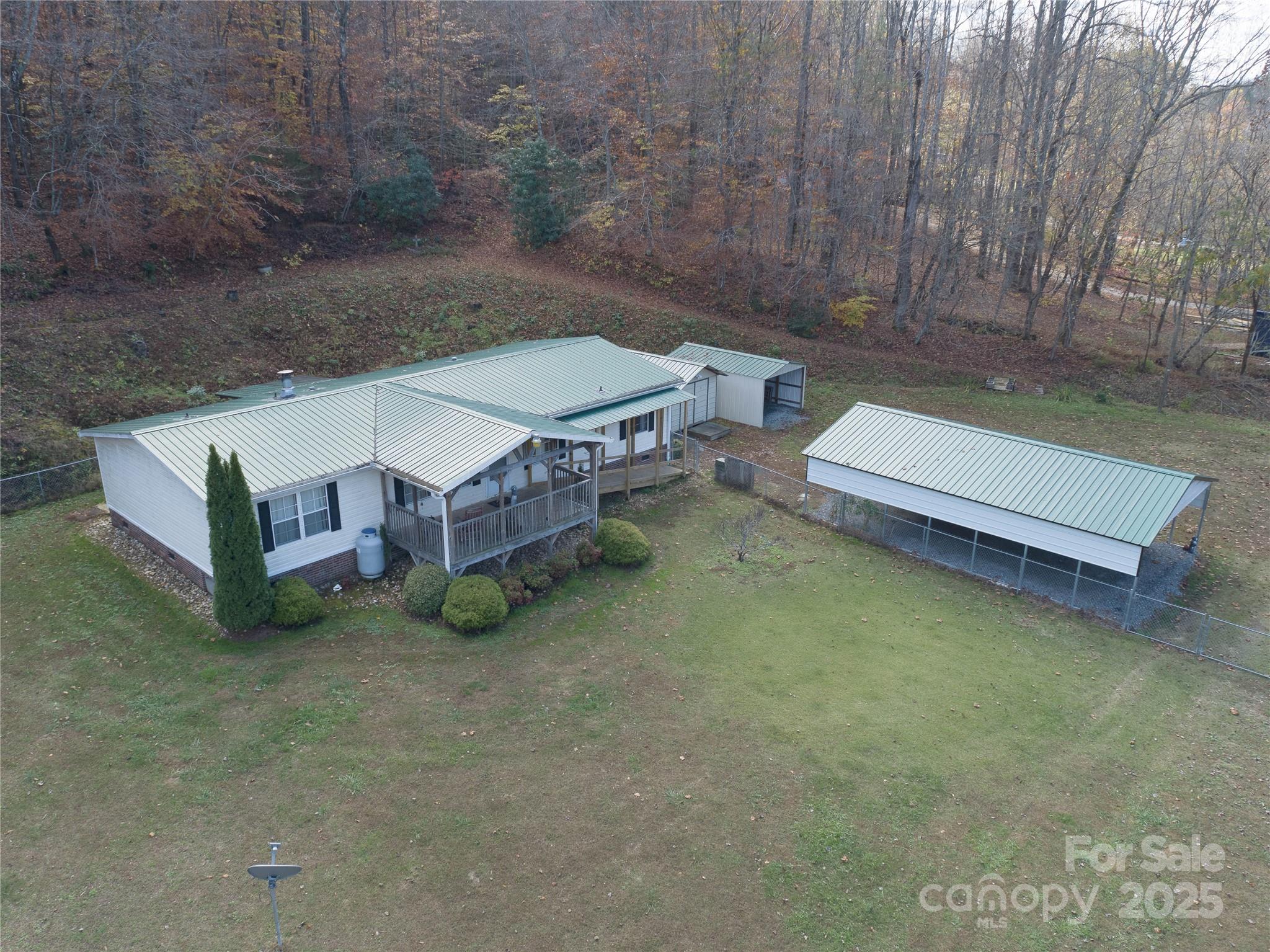 1922 Zacks Fork Road Lenoir, NC 28645 - Photo 27 of 27 a backyard of a house with table and chairs