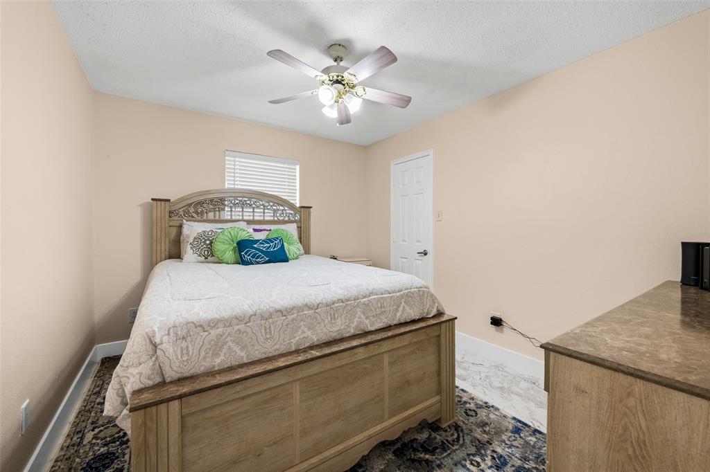 1424 Jacksons Run Greenville, TX 75402 - Photo 12 of 23 a bedroom with a bed and a chandelier