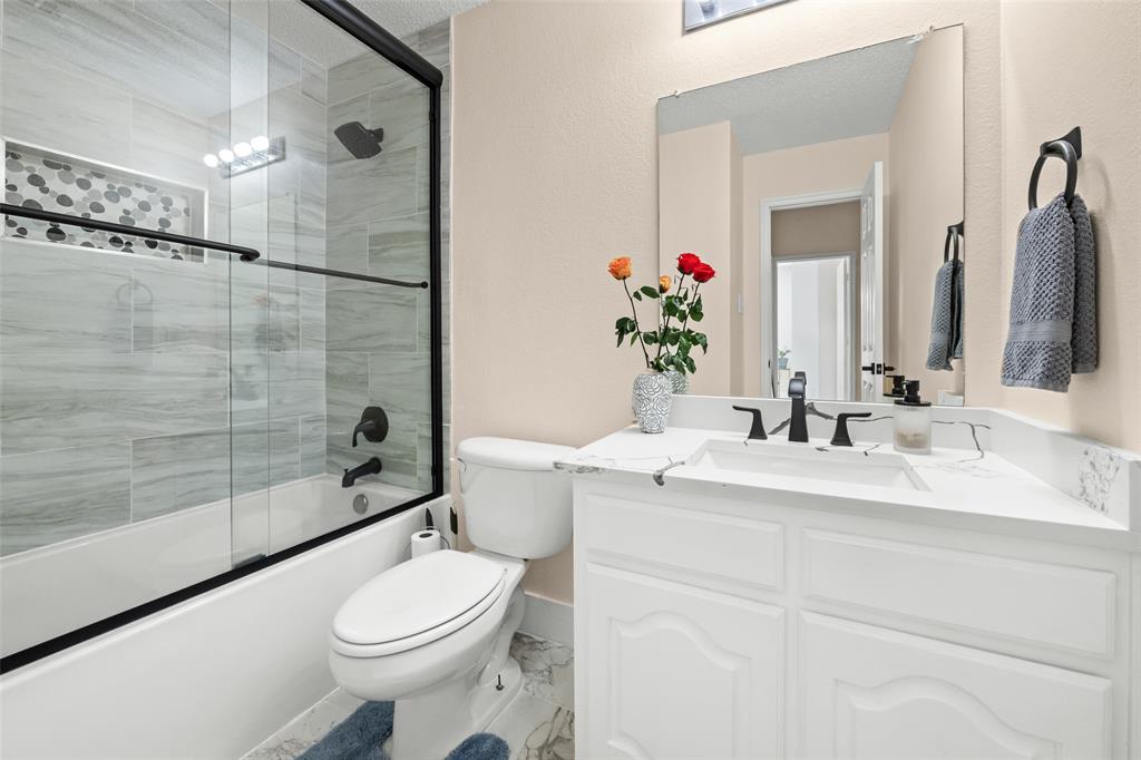 1424 Jacksons Run Greenville, TX 75402 - Photo 15 of 23 a bathroom with a sink a toilet and shower