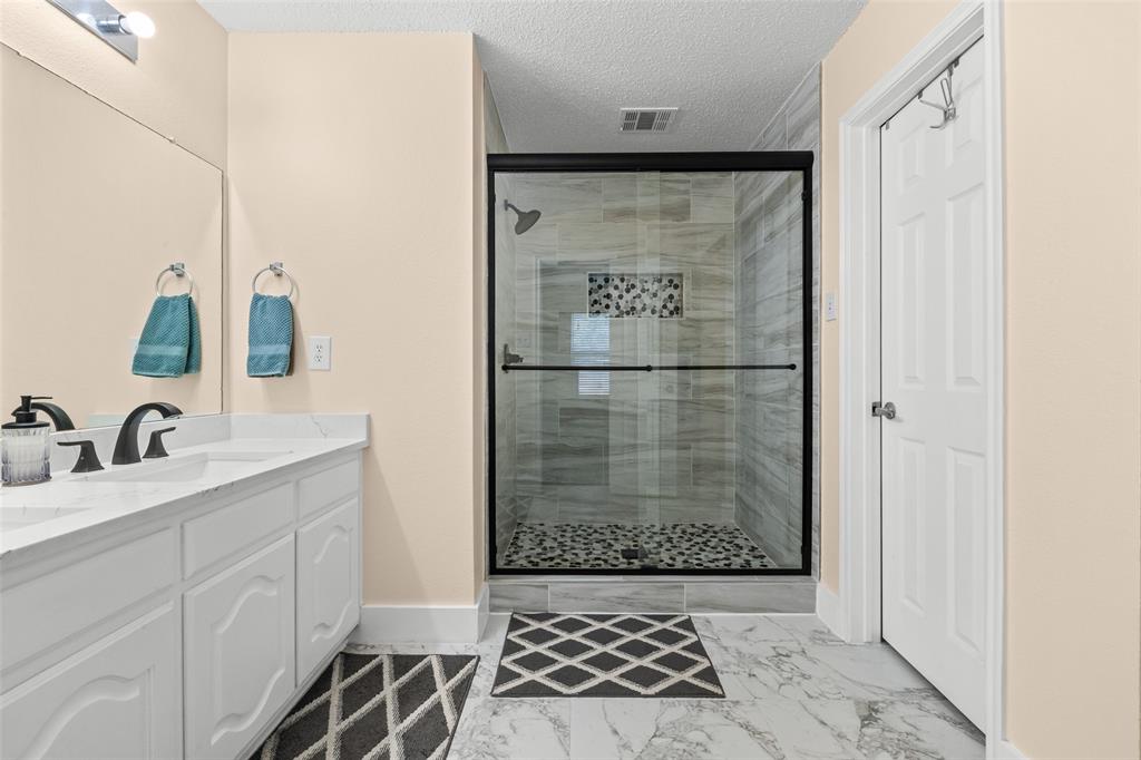 1424 Jacksons Run Greenville, TX 75402 - Photo 18 of 23 a bathroom with a shower and a sink