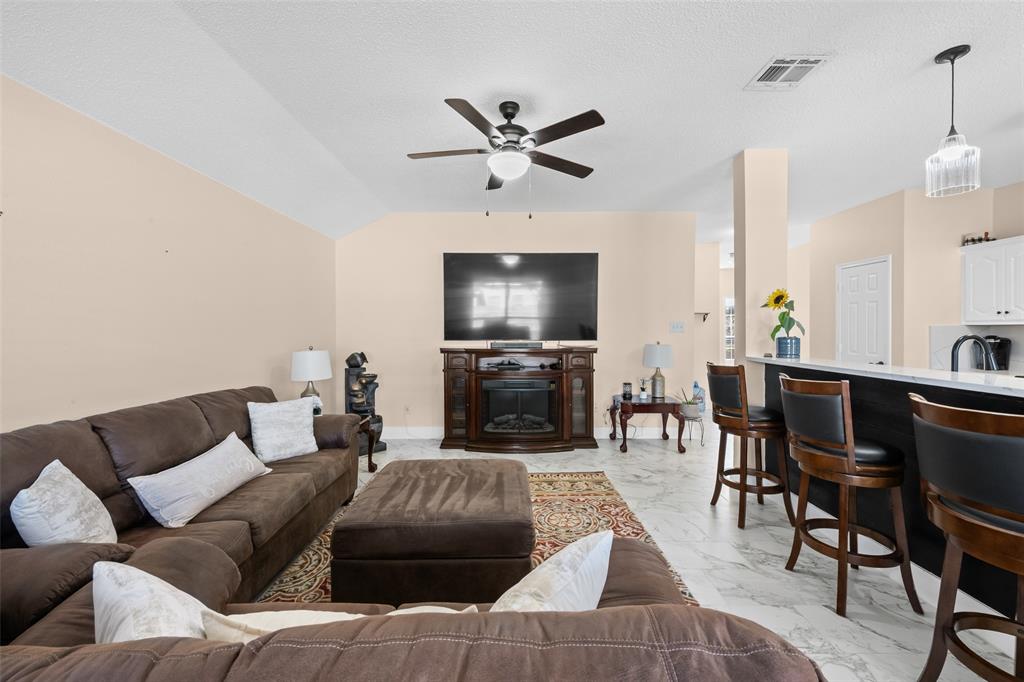 1424 Jacksons Run Greenville, TX 75402 - Photo 6 of 23 a living room with furniture and a flat screen tv with wooden floor