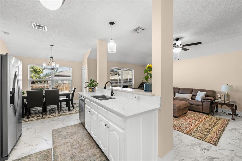 1424 Jacksons Run Greenville, TX 75402 - Photo 7 of 23 a large white kitchen with sink and a refrigerator