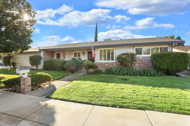 a front view of house with yard and green space